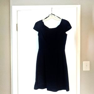 Navy blue short sleeve dress with crisscross back.